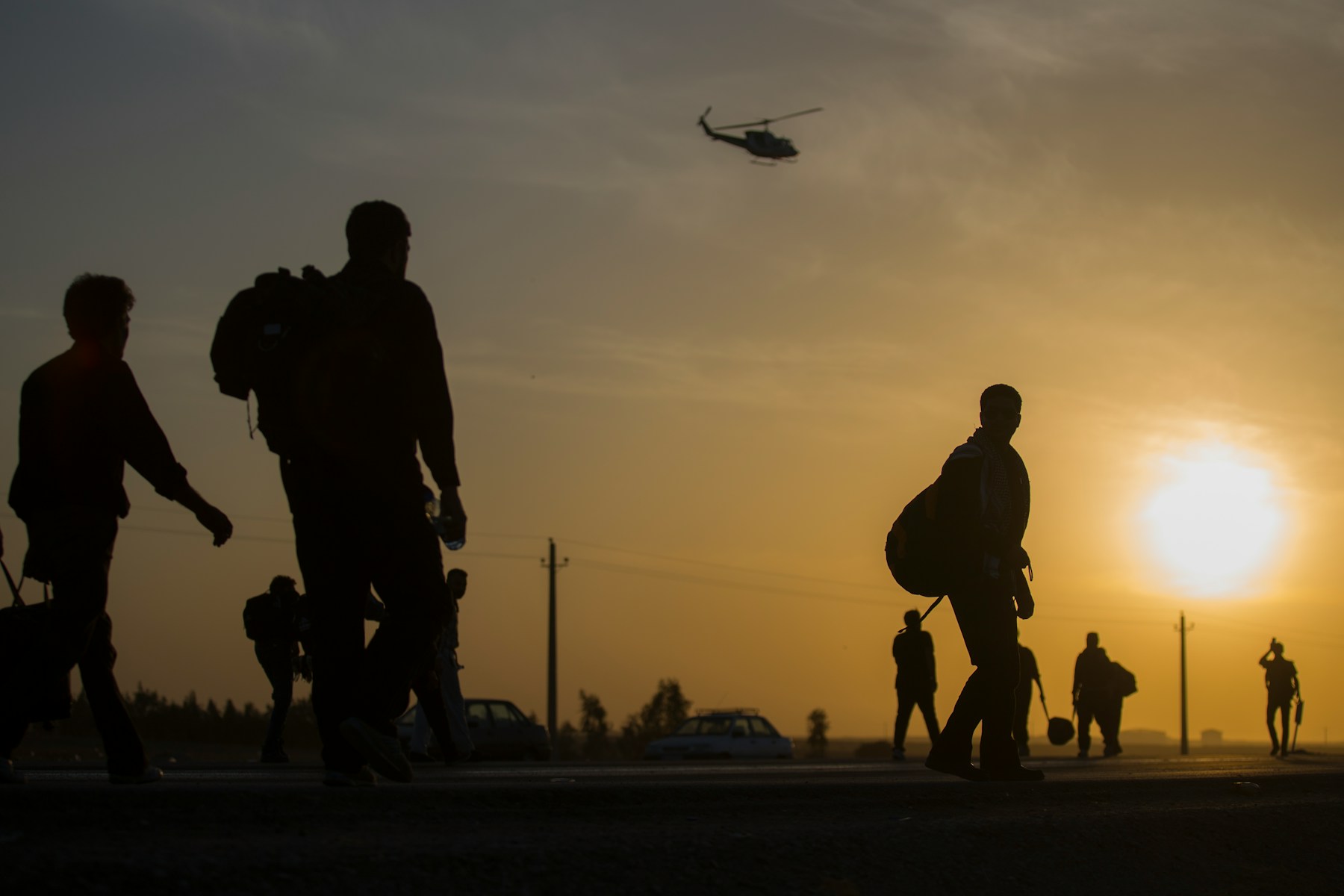 crowd walking at sunset